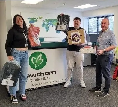 Hawthorn Logistics staff presenting raffle support items for the Irish Cave Rescue Organisation